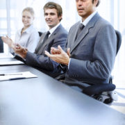 kaiserkom | Successful applauding executives sitting at the table